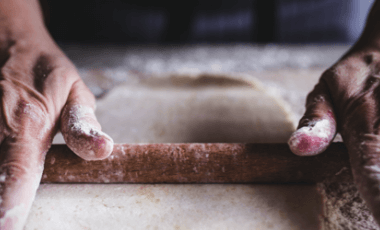 hands rolling flour