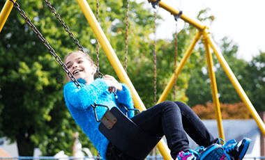 child with diabetes on swing