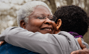 senior woman with diabetes hugging