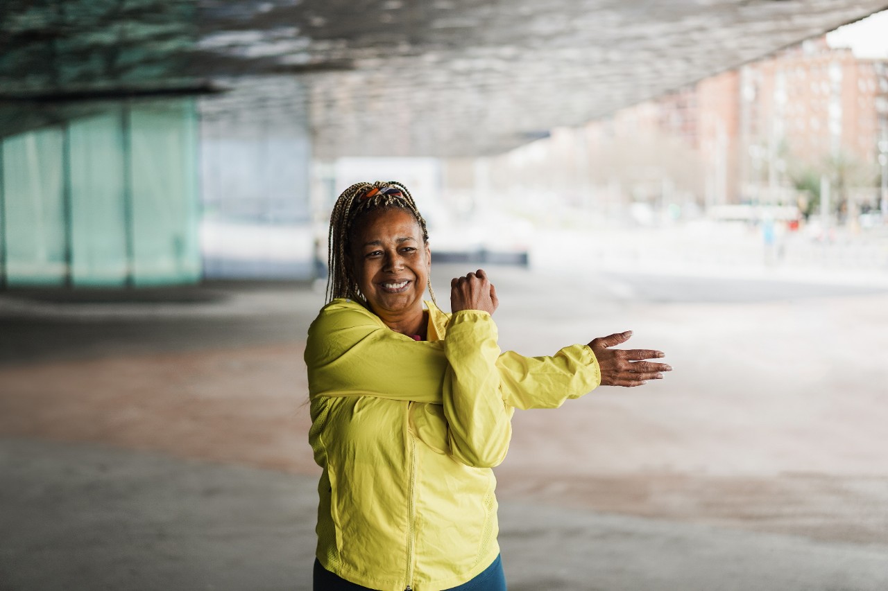 Woman stretching her arm across her body