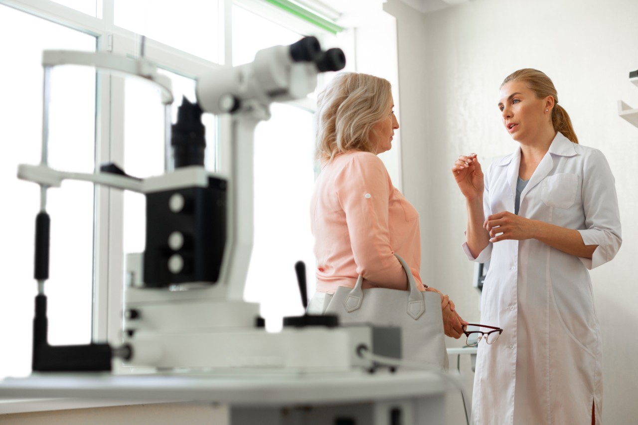 Doctor speaking to woman in examination room